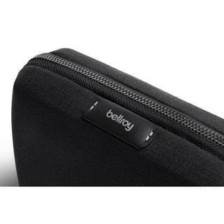 Bellroy Tech Kit Compact in black recycled fabric with visible zipper and branded label close-up