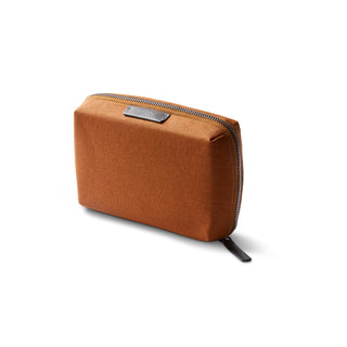 Bellroy Tech Kit Compact in rust brown recycled fabric with zippered closure and leather pull tab