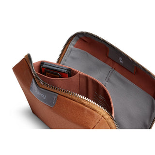 Bellroy Tech Kit Compact in brown fabric showing interior compartments and gray lining with zipper open