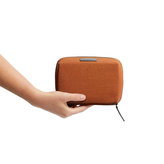 Bellroy Tech Kit Compact in recycled fabric held in hand showing compact size and textured surface