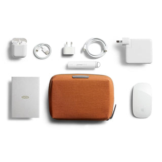 Bellroy Tech Kit Compact in rust fabric surrounded by tech accessories on white background