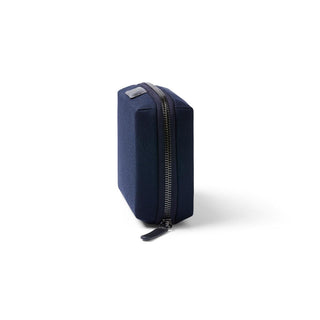 Bellroy Tech Kit Compact in navy blue showing side profile with sturdy zipper and recycled fabric texture