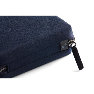 Bellroy Tech Kit Compact navy blue fabric with durable zipper and signature logo tag close-up