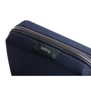 Bellroy Tech Kit Compact in dark navy with visible zipper and textured recycled fabric close-up
