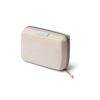 Bellroy Tech Kit Compact in beige recycled fabric with zip closure shown at slight angle