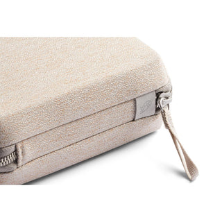 Bellroy Tech Kit Compact in beige recycled fabric with textured surface and zipper pull tab close-up