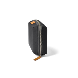 Bellroy Tech Kit Compact in black recycled fabric with silver zipper and leather pull tab angled view