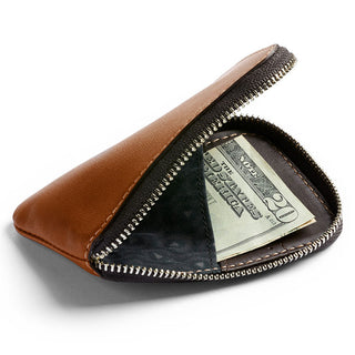 Bellroy Card Pocket with brown leather exterior, black fabric interior, and zipper closure holding cash