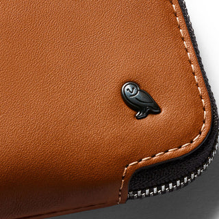Bellroy Card Pocket in tan leather with contrast stitching and embossed black owl logo close-up view