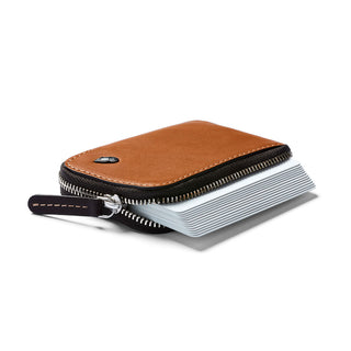 Bellroy Card Pocket in tan leather with zipper and fanned-out card slots on white background