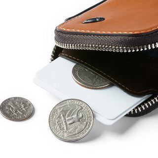 Bellroy Card Pocket showing tan leather exterior with card and coins partially inside zipper compartment
