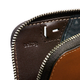 Bellroy Card Pocket close-up showing brown leather interior and metal zipper detail with embossed logo