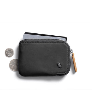 Bellroy Card Pocket in black leather with zipper and leather pull tab holding cards and coins