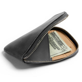 Bellroy Card Pocket in black leather with zipper partially open showing folded bills inside