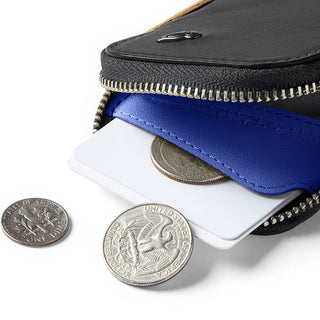 Bellroy Card Pocket in black leather with blue interior holding cards and coins inside zipper pouch