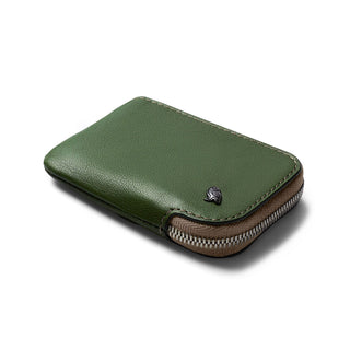 Bellroy Card Pocket in green leather with zipper and metal logo detail on a white background