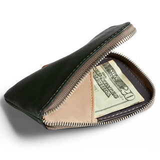 Bellroy Card Pocket in dark green leather partially unzipped showing fabric interior with cash inside