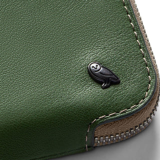 Bellroy Card Pocket close-up showing green leather texture and black bird logo with stitched edges