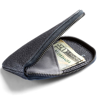 Bellroy Card Pocket in textured dark leather with zipper partially open showing folded bills inside