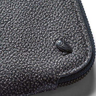 Black textured leather Bellroy Card Pocket corner with embossed owl logo and zipper detail