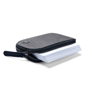 Bellroy Card Pocket in textured dark leather with zipper partially open showing stacked cards inside