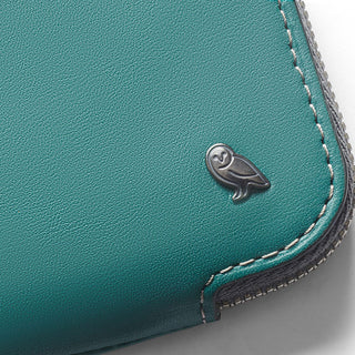 Bellroy Card Pocket in teal leather with owl logo detail and fine contrast stitching close-up