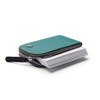 Bellroy Card Pocket in green leather with zipper open showing stacked cards inside compact design