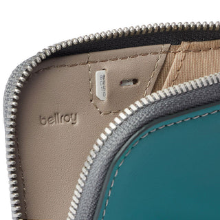 Bellroy Card Pocket close-up showing turquoise leather and beige interior with zipper detail