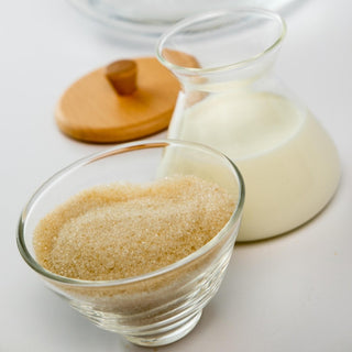 Chemex Cream and Sugar Set with clear glass containers holding sugar and cream plus a wooden lid accessory
