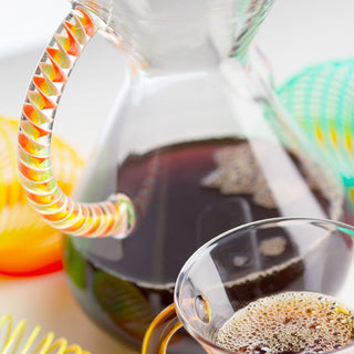 CHEMEX® Six Cup Glass Handle coffee maker with clear glass handle and brewed dark coffee inside