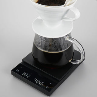 HARIO Polaris Coffee Scale in black with digital timer and drip coffee setup on top