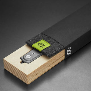 James The Duval Knife partially sheathed in black felt pouch with green tab inside natural wooden box
