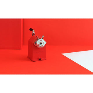 Caran d'Ache Pencil Sharpener Standard Edition metal sharpener in red with chrome cutter on red background
