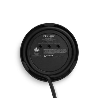 Bottom view of Fellow Clyde Electric Kettle (120V) (1500ml/50oz) showing black base with cord and brand logo