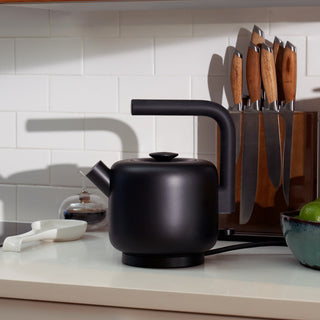 Fellow Clyde Electric Kettle (120V) (1500ml/50oz) matte black stainless steel body on kitchen counter