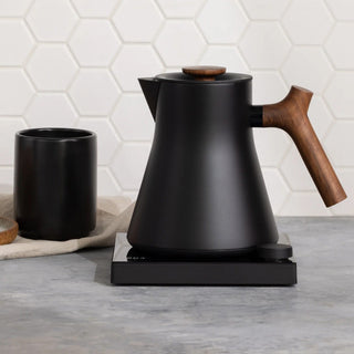 Fellow Corvo EKG Pro Studio Electric Kettle (120V) black matte with wooden handle on countertop