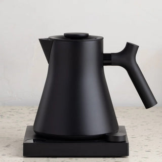 Fellow Corvo EKG Pro Electric Kettle (120V) in matte black with ergonomic handle on black base