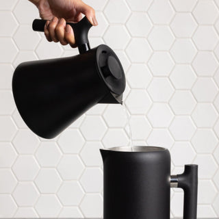 FELLOW Fellow Corvo EKG Pro Electric Kettle (120V) pouring water, matte black stainless steel body