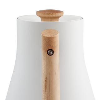 Fellow Corvo EKG Electric Kettle (120V) with smooth white body and natural wooden handle close-up view