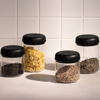 Fellow Electric Atmos Vacuum Canister - Clear Glass jars with black lids holding various dry food items