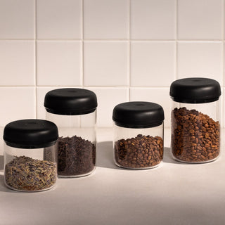 Fellow Electric Atmos Vacuum Canister - Clear Glass jars with black lids storing coffee and tea ingredients