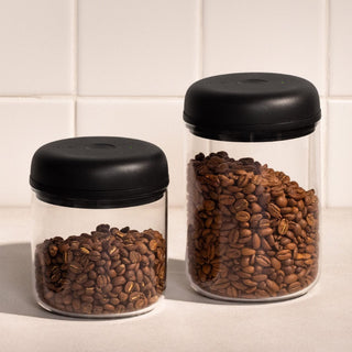 Fellow Electric Atmos Vacuum Canister - Clear Glass jars with black lids storing coffee beans on countertop