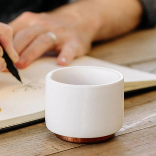 FELLOW Monty Espresso Cups (3oz/89ml) (2-Pack) white ceramic with copper bottom on wooden table
