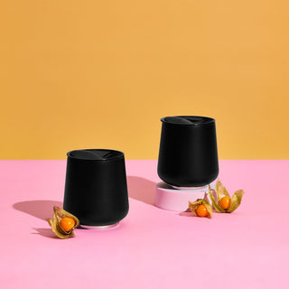 FELLOW Ruby Wine Tumbler (12oz/355ml) black stainless steel with sealed lids on pink surface