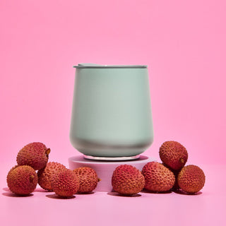 FELLOW Ruby Wine Tumbler (12oz/355ml) matte green stainless steel with magnetic lid on pink background