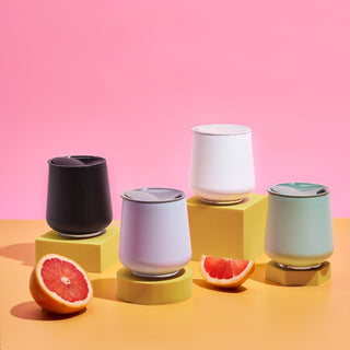 FELLOW Ruby Wine Tumbler (12oz/355ml) in assorted colors with magnetic BPA-free lids on yellow blocks