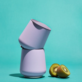 FELLOW Ruby Wine Tumbler (12oz/355ml) in soft purple matte finish with magnetic BPA-free lid stacked with kiwi fruit