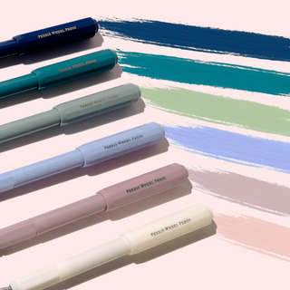 Six pastel-colored The Carousel Fountain Pen - Seaside Glass | Ferris Wheel Press pens with ferris wheel press branding and matching ink streaks.