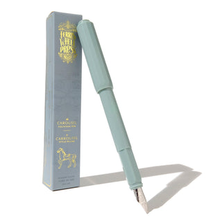 The Carousel Fountain Pen - Seaside Glass | Ferris Wheel Press with light blue body and silver nib beside branded box by ferris wheel press