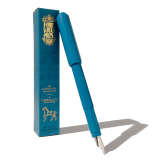 The Carousel Fountain Pen - Tattler's Teal | Ferris Wheel Press with teal box and silver nib casting a shadow on white surface